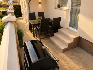 a car parked on a porch with a table and chairs at Villa Zlatan Poolside in Bosanska Gradiška