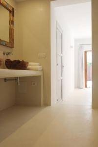 a bathroom with a sink and a mirror at A beautiful villa close to the beach in Playa Migjorn +42 photos