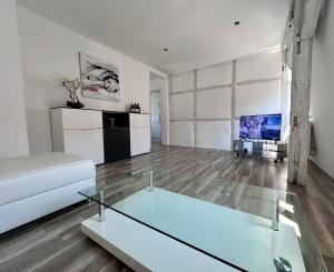a living room with a white couch and a tv at Comfort in Bamberg