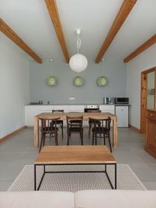 a kitchen with wooden tables and chairs in a room at Füveskert in Erdőbénye +8 photos