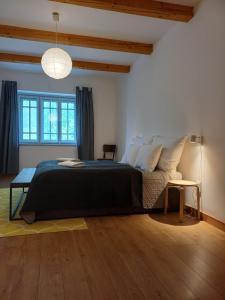 a bedroom with a large bed and a table at Füveskert in Erdőbénye