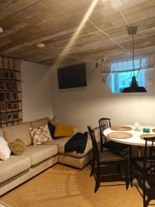 a living room with a couch and a table at Tyynynpaikka in Tampere