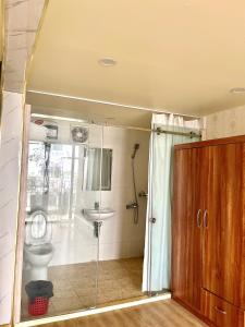 a bathroom with a shower and a toilet and a sink at Chillax in Ha Long +7 photos