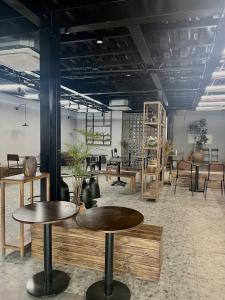 a room with tables and chairs in a room at Chillax in Ha Long