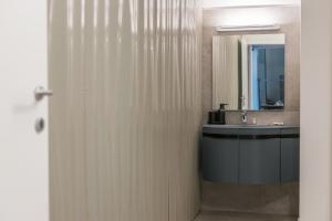a bathroom with a sink and a mirror at Effealatapartments - EdenLoft in Senigallia +58 photos
