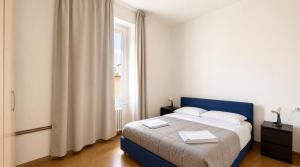 a bedroom with a blue bed with a window at A&D BnB in Porretta Terme