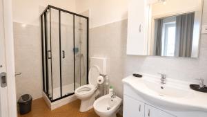 a bathroom with a toilet and a sink and a shower at A&D BnB in Porretta Terme