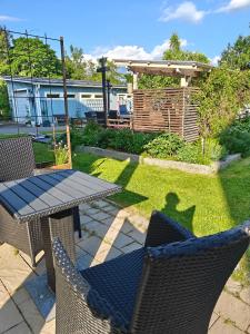 a patio with a table and chairs in a yard at Tyynynpaikka in Tampere
