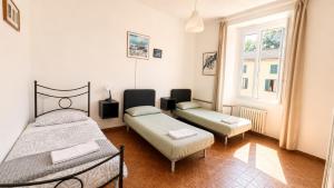 a bedroom with two beds and a window at A&D BnB in Porretta Terme +7 photos