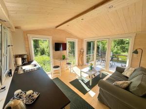 a living room with a couch and a table at Älg Stuga in Kosta