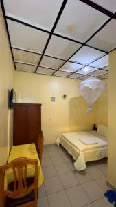a room with a bed and a table in it at piece motel in Kigali