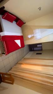 a room with two bunk beds with red and white pillows at piece motel in Kigali