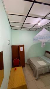 a room with a bed and a table in a room at piece motel in Kigali +4 photos