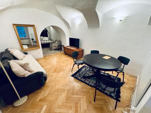 a living room with a table and a couch at The sanctuary ljubljana in Ljubljana