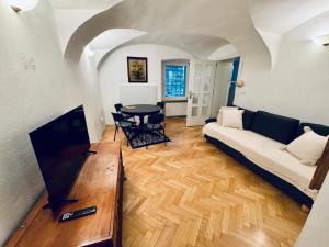a living room with a couch and a table at The sanctuary ljubljana in Ljubljana