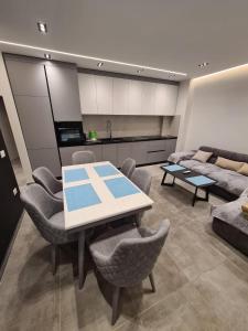 a kitchen and living room with a table and chairs at Beach House Lleshi in Tale +16 photos