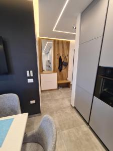 a room with chairs and a table and a mirror at Beach House Lleshi in Tale