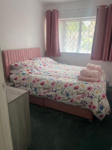a bedroom with a bed with towels on it at Newly refurbished Annexe in Wareham