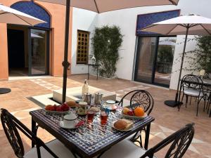 a table with fruits and drinks on it on a patio at Patios do Algarve in Ferragudo