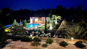 a villa with a swimming pool at night at Patios do Algarve in Ferragudo