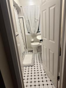 a bathroom with a toilet and a window at Logans Lodge in Minneapolis