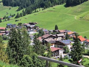 a small town in a green field with houses at Hotel Pension Haid in Sankt Leonhard im Pitztal