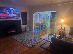 a living room with a fireplace and a tv at Logans Lodge in Minneapolis