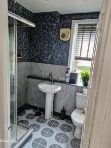 a bathroom with a sink and a toilet at Millers Ben Nevis View in Caol