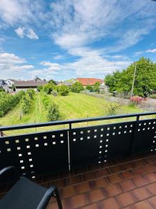 a balcony with a view of a green field at FeWo Ruf in Sasbach am Kaiserstuhl