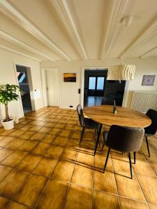 a dining room with a wooden table and chairs at FeWo Ruf in Sasbach am Kaiserstuhl