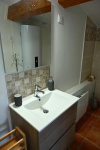 a bathroom with a sink and a mirror at Les Mourguettes in Tulette +13 photos