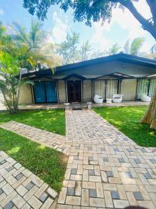 a house with a brick driveway in front of it at Trump House in Anuradhapura