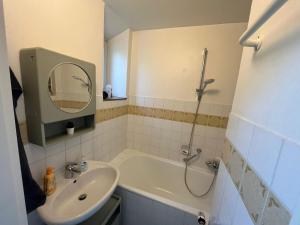 a bathroom with a shower and a sink and a tub at Süße Marie 19 - Coffee for free - in Karlsruhe
