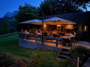 a group of people sitting at a restaurant on a deck at Genusshof Mesner Aktiv in Liesing