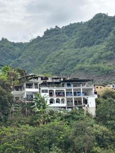 a large white building on top of a hill at Casa Miralagos in Santa Cruz La Laguna