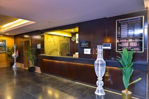 a waiting room with a counter and a glass bottle at تارا للشقق المخدومة in Riyadh