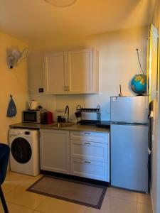 a kitchen with a refrigerator and a dishwasher at apartments with separate kitchen by the sea in Ashdod