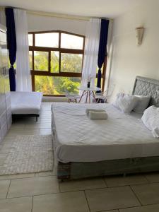 a bedroom with a large bed and a large window at Ocean view villa in Diani Beach +30 photos