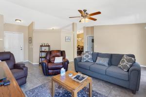 a living room with two couches and a table at Peaceful Valley in Tucson
