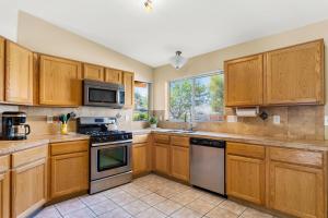 a kitchen with wooden cabinets and stainless steel appliances at Peaceful Valley in Tucson