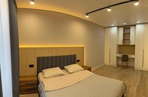 a bedroom with a large bed in a room at Dream 71 in Lutsk