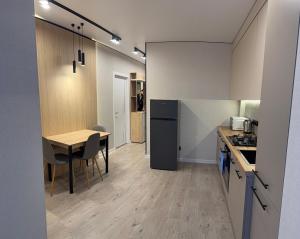 a kitchen and dining room with a table and a counter at Dream 71 in Lutsk