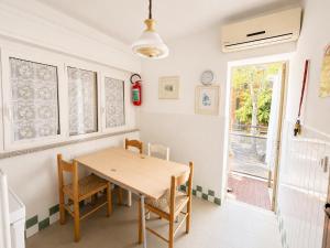 a dining room with a wooden table and chairs at Anthea - Timavo apartment 2 in Lignano Sabbiadoro