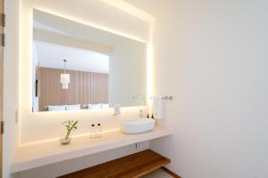 a bathroom with a sink and a mirror at Hotel Casa Eteca in San Pedro y San Pablo Etla
