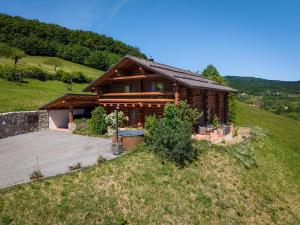a log house on a hill with a yard at Chalet Val d'Or in Nová Baňa