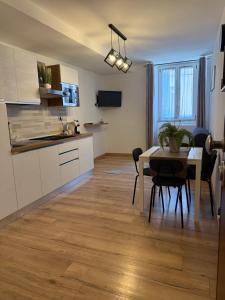 a kitchen and dining room with a table and a dining room at Monica's home in Ariccia
