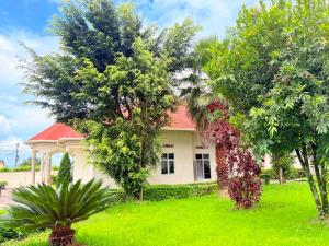 a house with trees in front of it at Volcanoes Stay Musanze in Kigali