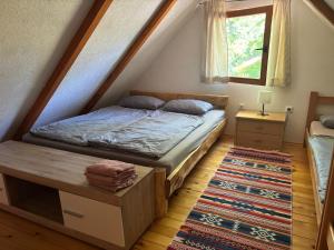 a bedroom with a bed and a window and a rug at Pure Nature in Bihać