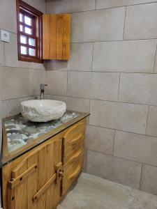 a bathroom with a sink and a stone counter top at Moinho da Quinta da Esperança in Ourém +25 photos