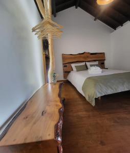 a bedroom with two beds and a wooden floor at Moinho da Quinta da Esperança in Ourém
